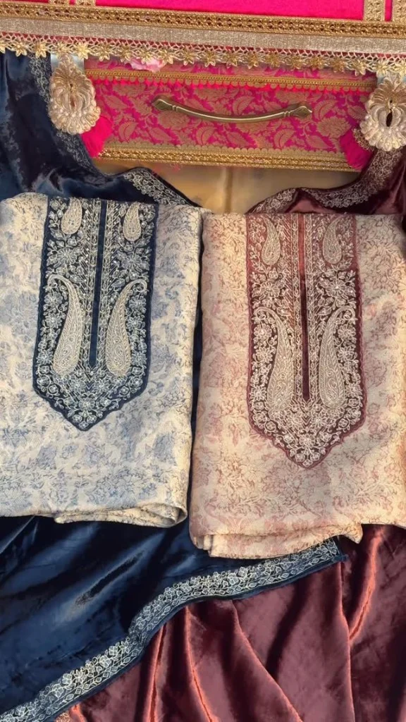 Embroidered neckline pieces laid on navy and maroon velvet